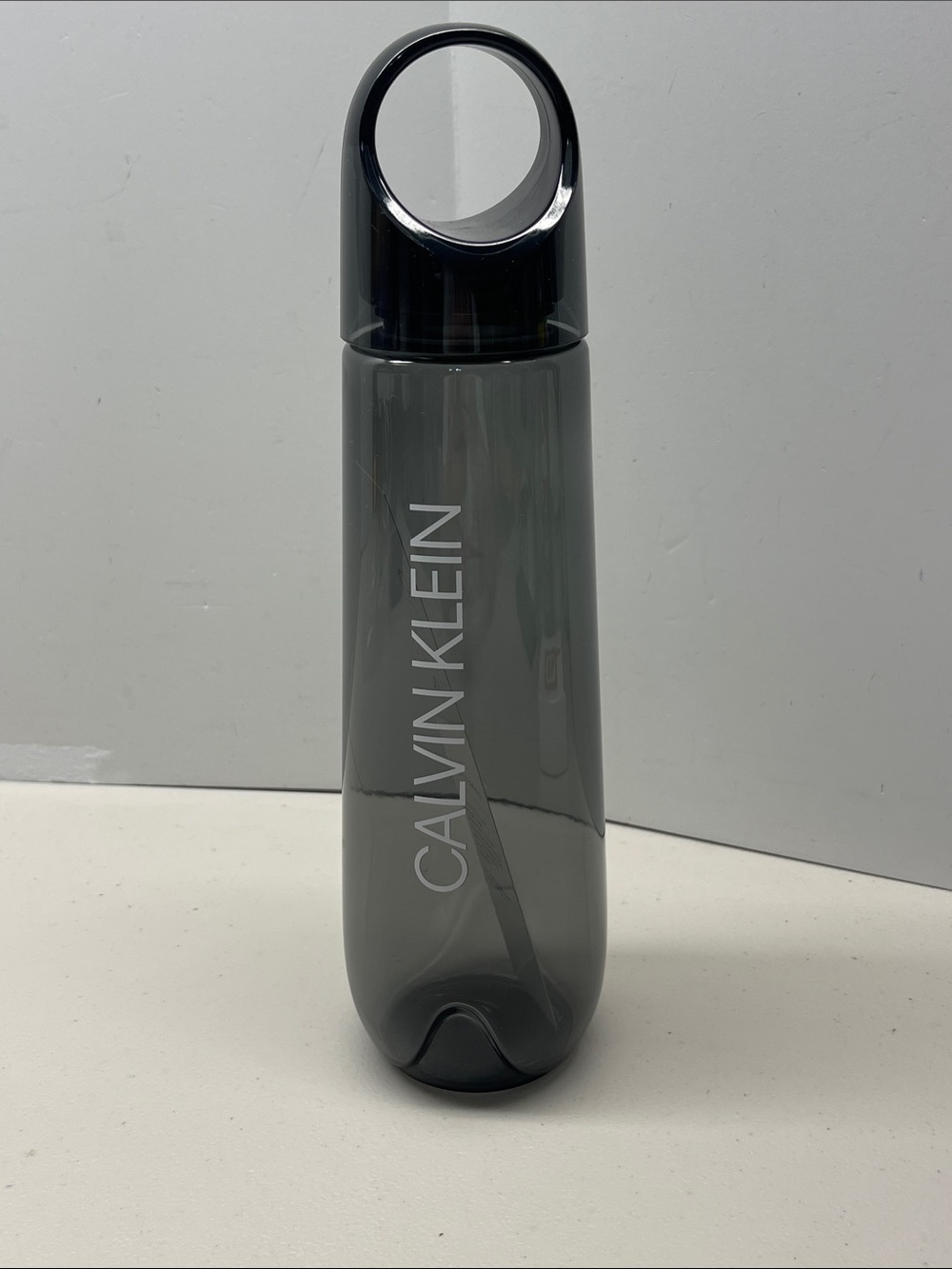 Calvin Klein Gray Transparent Loop-Top Bottle. NEW